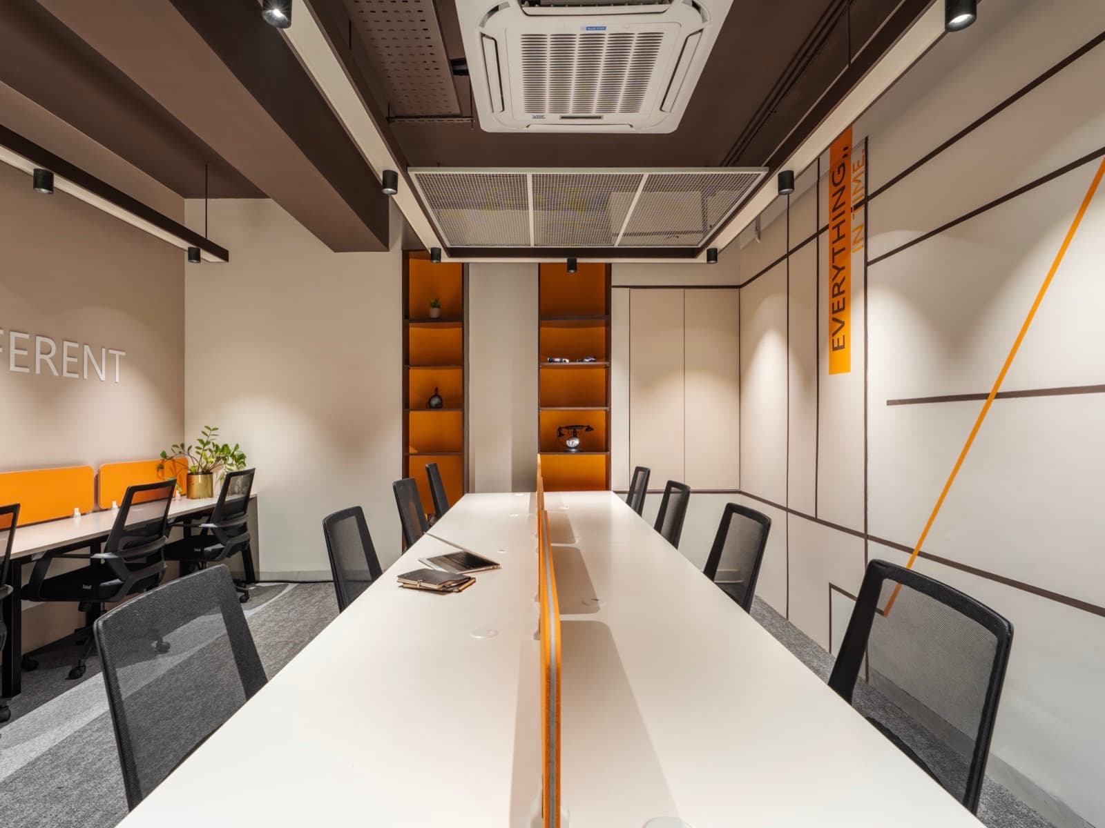 Different lettering and display shelving over the twelve-seat desk rows at Fliqzo Coimbatore