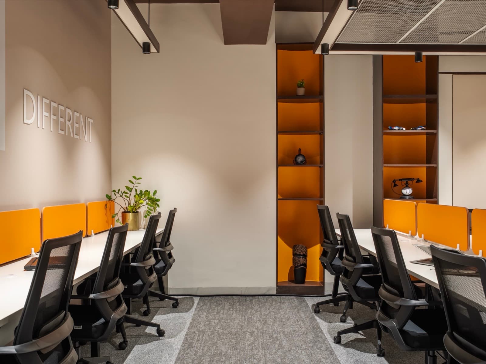Desk rows beneath the Different mural in the 12 seater private office at Fliqzo Coimbatore