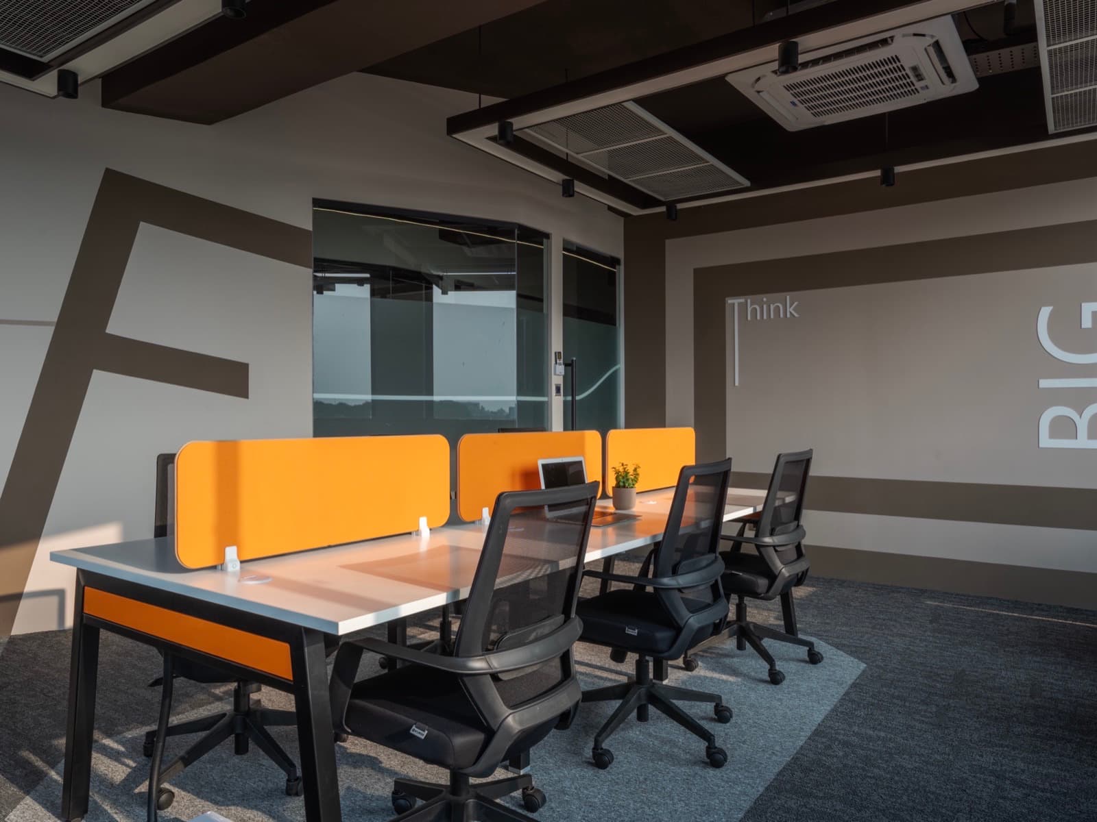 Think Big corner and glass meeting nook at golden hour in the 16 seater lake view office at Fliqzo
