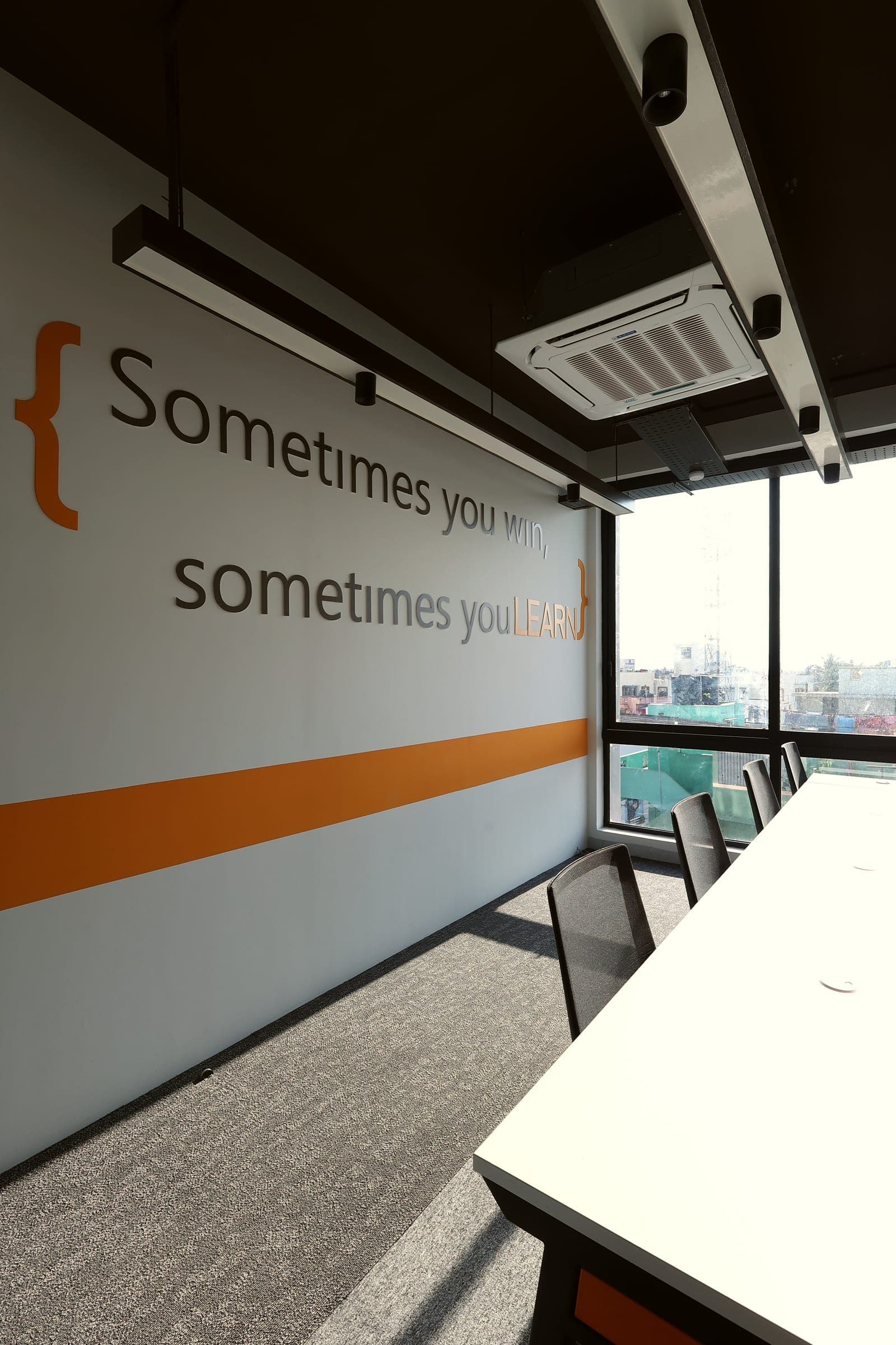 Sometimes You Win Sometimes You Learn quote wall beside the window in the 4 seater private office at Fliqzo