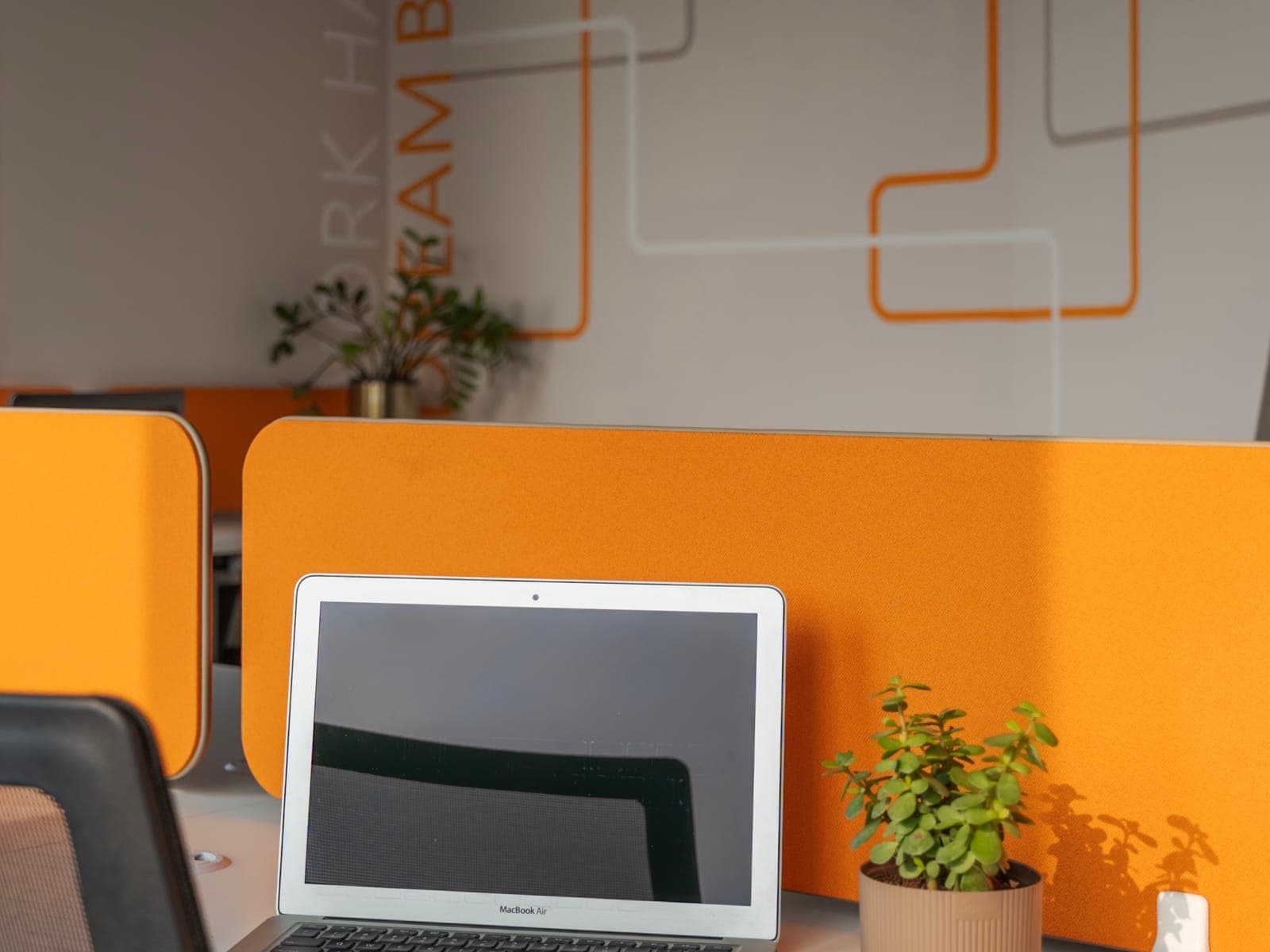 Work Hard Dream Big lettering behind a laptop desk in the 4 seater lake view private office at Fliqzo