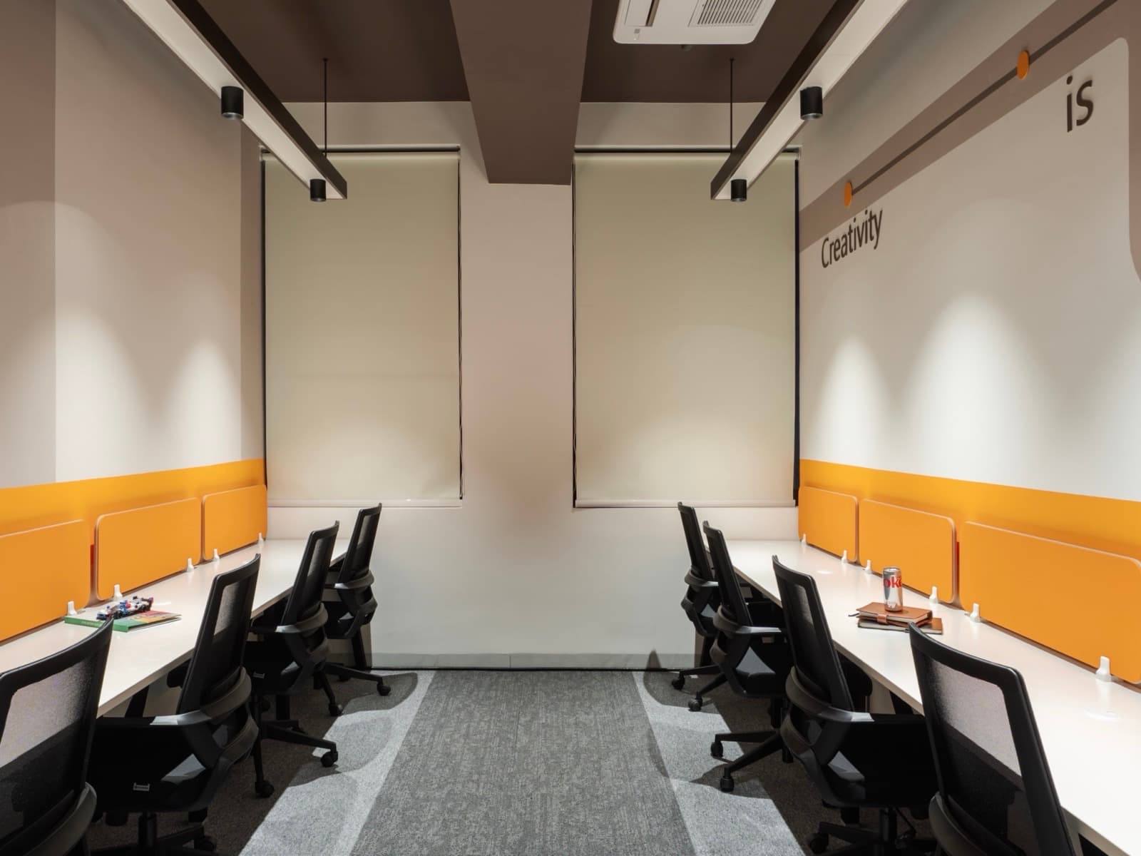 Creativity wall lettering over facing desk rows in the 8 seater lake view private office at Fliqzo